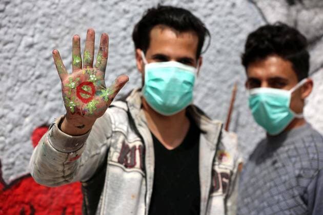 March 28, 2020, Khan Younis, Gaza Strip, Palestinian Territory: Palestinian artists draw a mural during awareness campaign about the coronavirus COVID-19, in Khan Younis in the southern of Gaza Strip on March 28, 2020 Khan Younis Palestinian Territory - ZUMAap3_ 20200328_zaf_ap3_003 Copyright: xAshrafxAmrax