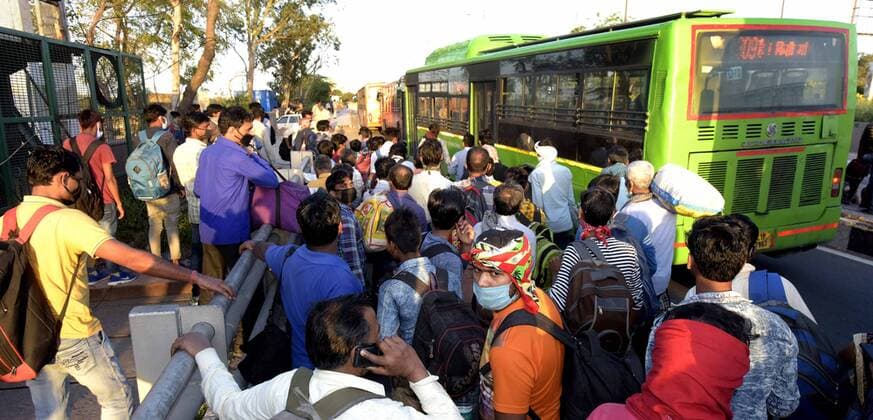 NEW DELHI, INDIA - MARCH 28: Migrant workers wait at a petrol pump in Lal Kuan following Uttar Pradesh government?s call to arrange buses for the workers returning to their native state, on Day 4 of the 21 day nationwide lockdown -- to check the spread of coronavirus, on March 28, 2020 in New Delhi, India. (Photo by Sushil Kumar Hindustan Times ) Coronavirus Update: Amid Lockdown, A Sea Of Migrants In Delhi-NCR Try To Find Their Way Back Home