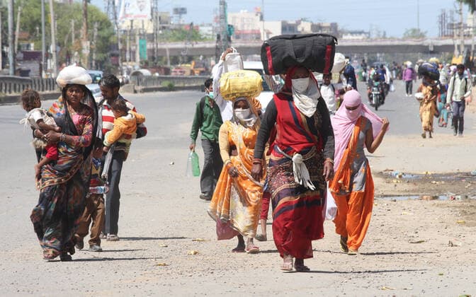 GURUGRAM, INDIA - MARCH 28: Migrant workers going back to their towns and villages, on day 4 of the nationwide lockdown to check the spread of coronavirus, at Delhi-Gurugram expressway near Delhi- Gurugram border, on March 28, 2020 in Gurugram, India. (Photo by Yogendra Kumar Hindustan Times ) Coronavirus Update: Amid Lockdown, A Sea Of Migrants In Delhi-NCR Try To Find Their Way Back Home