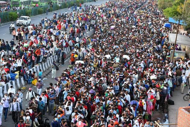 NEW DELHI, INDIA - MARCH 28: A wave of migrant workers seen at Anand Vihar Bus Terminus near the Delhi - UP border following Uttar Pradesh government?s call to arrange buses for the workers returning to their native state, on Day 4 of the 21 day nationwide lockdown -- to check the spread of coronavirus, on March 28, 2020 in New Delhi, India. (Photo by Raj K Raj Hindustan Times ) Coronavirus Update: Amid Lockdown, A Sea Of Migrants In Delhi-NCR Try To Find Their Way Back Home