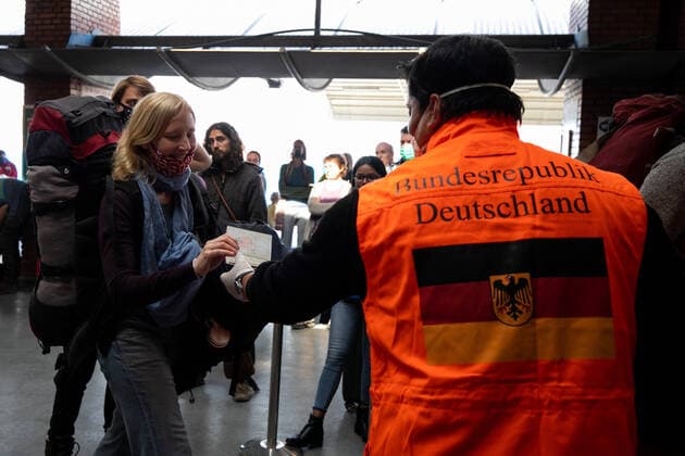 March 27, 2020, Kathmandu, Nepal: A staff from German embassy checks a passenger s passport for their chartered flight back home at Tribhuvan International Airport in Kathmandu..A rescue flight was arranged by the German government to pick up tourists who had been stranded in Nepal due to the government-imposed lock-down amid concerns over the spread of Coronavirus. Kathmandu Nepal - ZUMA Pla 20200327_mda_s197_270 Copyright: xPrabinxRanabhatx