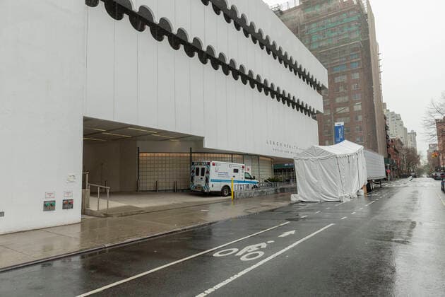 Sightseeing in New York City in times of COVID-19 Medical emergency vehicle & makeshift morgue trailer parked next to Lenox Health Medical Pavilion part of Northwell Health system in Greenwich Village of Manhattan New York New York United States Copyright: LevxRadin