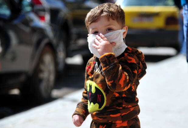 (200329) -- DAMASCUS, March 29, 2020 -- A boy is seen wearing a mask in Damascus, capital of Syria, on March 28, 2020. Syria has so far registered five coronavirus cases. (Photo by Xinhua) SYRIA-DAMASCUS-COVID-19-FIVE CASES AmmarxSafarjalani 