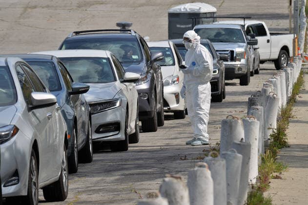 Medical and fire department personnel distribute self-testing coronavirus kits to residents who made appointments, in a parking lot adjacent to Dodger Stadium in Los Angeles on Saturday, March 28, 2020. The number of confirmed cases of COVID-19, the disease caused by the.coronavirus in Los Angeles County stood at 1,465 as of midday Saturday, with 26 deaths. The county s Department of Public Health reported 257 new cases on Friday, and 421 on Thursday, the highest one-day total so far.  LAP2020032808 JIMxRUYMEN