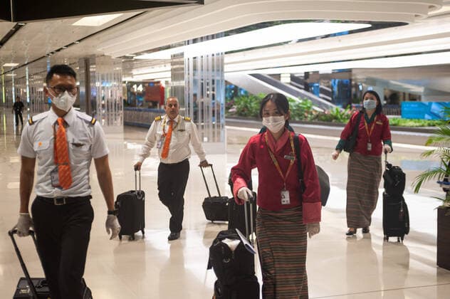 28 03 2020, Singapore, Republic of Singapore, Asia Druk Air pilots and flight attendants from Bhutan will wear respirators and rubber gloves on arrival at Changi Airport Terminal 1 to protect themselves from infection with the pandemic corona virus