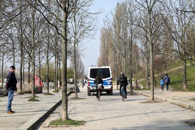 28 03 2020, Berlin Germany the warm weekend draws people out in the Corona crisis The police patrol in Mauerpark People follow the rules and keep their distance outdoors in the sun