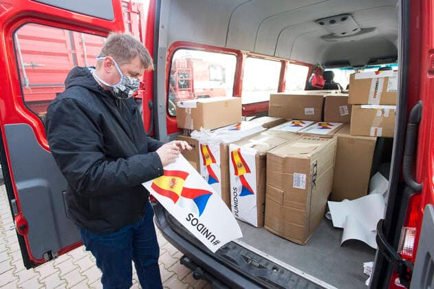 Czech Foreign Affairs Minister Tomas Petricek (Social Democrats, CSSD) prepares boxes with an aid, in Opocinek, Pardubice, Czech Republic, on March 29, 2020. The Czech Republic launched its aid to Spain and Italy, the European countries that are the most afflicted by the novel coronavirus pandemic, sending 20,000 protective suits from the police storage facility in Opocinek to them. (CTKxPhoto JosefxVostarek) CTKPhotoP202003290108101 JVO 006