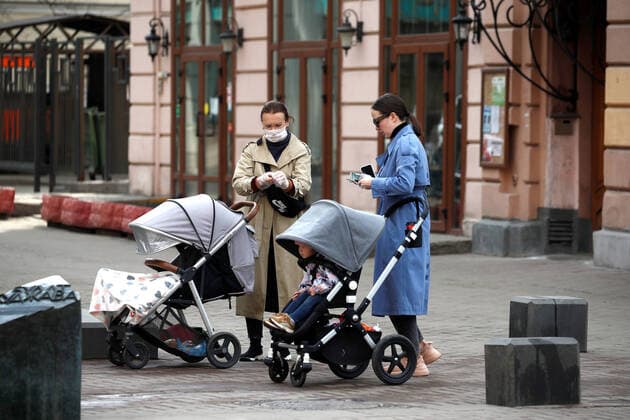 MOSCOW, RUSSIA - MARCH 29, 2020: Women with young children in Stary Arbat Street during the pandemic of the novel coronavirus (COVID-19). Artyom Geodakyan TASS  TS0D3C44
