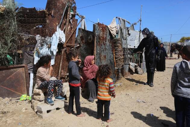 March 29, 2020, Khan Younis, Gaza Strip, Palestinian Territory: Palestinian workers spray disinfectant as a preventive measure amid fears of the spread of the coronavirus at Nahr al-Bared refugee camp in Khan Younis in the southern Gaza Strip on March 29, 2020 Khan Younis Palestinian Territory - ZUMAap3_ 20200329_zaf_ap3_047 Copyright: xAshrafxAmrax