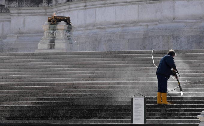 (200329) -- ROME, March 29, 2020 -- A staff member cleans the stairs in front of the Tomb of the Unknown Soldier in Rome, Italy, March 29 ,2020. The COVID-19 pandemic continued to claim victims in Italy as the deadline for the end of the government s national lockdown drew closer and experts warned it is too soon to lift restrictions. The death toll was 889 on Saturday, pushing the total to 10,023 fatalities since the pandemic first broke out in northern Italy on Feb. 21. (Photo by Alberto Lingria Xinhua) ITALY-ROME-COVID-19-DEATH TOLL ChengxTingting 