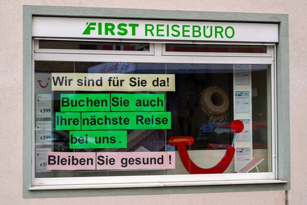 Impressions from Heidelberg District Kirchheim in Baden Württemberg in the days of the Corona Contact ban, the picture shows the window of a travel agency with the inscription We are here for you Book your next trip with us Stay healthy, First travel agency, travel industry, travel, tourism, shop busines xozx