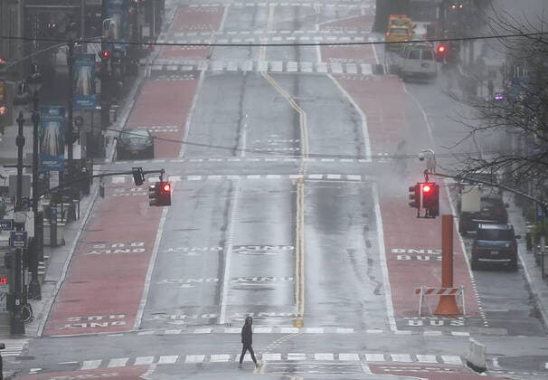 A woman crosses 42nd Street where pedestrian and automobile traffic remain almost non-existent in New York City on Sunday, March 29, 2020. On Saturday the Centers for Disease Control and Protection issued a 14-day travel advisory for New York, New Jersey and Connecticut. The number of confirmed COVID-19 cases in the tri-state area has surpassed 65,000 and at least 901 people are confirmed dead.  NYP20200329115 JOHNxANGELILLO