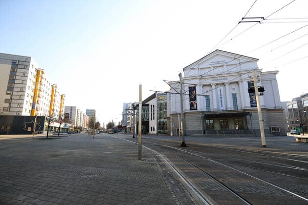 In the northern section of the Breite Weg in the city centre of Magdeburg Sachsen Anhalt with its opera house where a banner with the inscription Bleiben Sie Gesund ist Samstagnachmittags wegen der Corona Krise almost no people to see