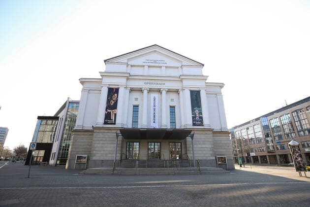 In the northern section of the Breite Weg in the city centre of Magdeburg Sachsen Anhalt with its opera house where a banner with the inscription Bleiben Sie Gesund ist Samstagnachmittags wegen der Corona Krise almost no people to see