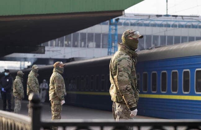 March 29, 2020, Kiev, Ukraine: Ukrainian border guard officers wearing protective suits as a preventive measure, stand next to a train with Ukrainian citizens after the evacuation..The special train from Kiev to Moscow evacuated Russian citizens to Moscow on 27 March 2020, and brought back Ukrainian citizens from Moscow to Kiev on 29 March 2020, after Ukrainian authorities shut the country s borders amid the spread of the COVID-19 coronavirus pandemic. Kiev Ukraine - ZUMAs197 20200329_zaa_s197_076 Copyright: xPavloxGoncharx