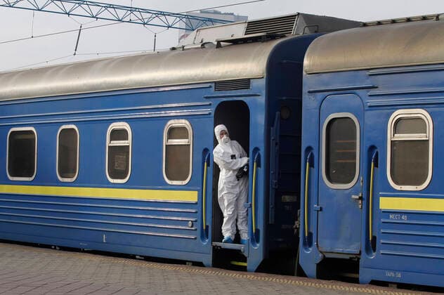March 29, 2020, Kiev, Ukraine: Ukrainian border guard officer wearing a protective suit as a preventive measure, standing inside a train with Ukrainian citizens after the evacuation..The special train from Kiev to Moscow evacuated Russian citizens to Moscow on 27 March 2020, and brought back Ukrainian citizens from Moscow to Kiev on 29 March 2020, after Ukrainian authorities shut the country s borders amid the spread of the COVID-19 coronavirus pandemic. Kiev Ukraine - ZUMAs197 20200329_zaa_s197_082 Copyright: xPavloxGoncharx