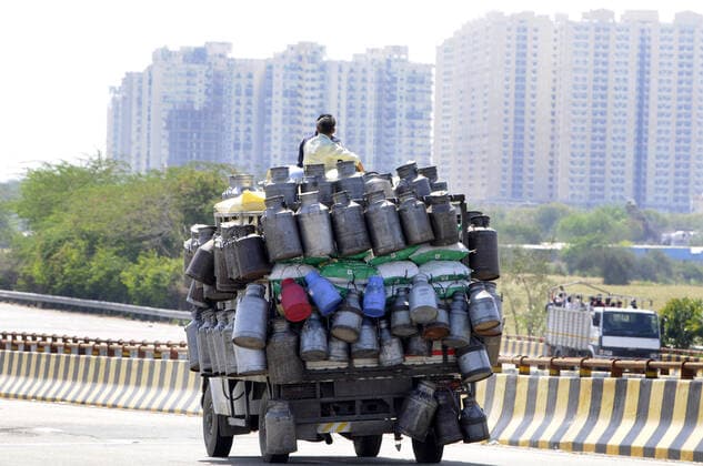 NOIDA, INDIA - MARCH 29: Milk canisters are transported on a vehicle, on day 5 of the nationwide lockdown imposed by PM Narendra Modi to check the spread of coronavirus, on March 29, 2020 in Noida, India. (Photo by Sunil Ghosh Hindustan Times ) Migrant Workers Head Home In Coronavirus Lockdown