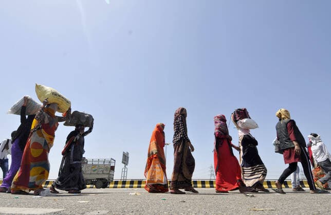 NOIDA, INDIA - MARCH 29: Migrant workers headed back to their towns and villages on foot, on day 5 of the nationwide lockdown imposed by PM Narendra Modi to check the spread of coronavirus, at Yamuna expressway zero point, on March 29, 2020 in Noida, India. (Photo by Sunil Ghosh Hindustan Times ) Migrant Workers Head Home In Coronavirus Lockdown