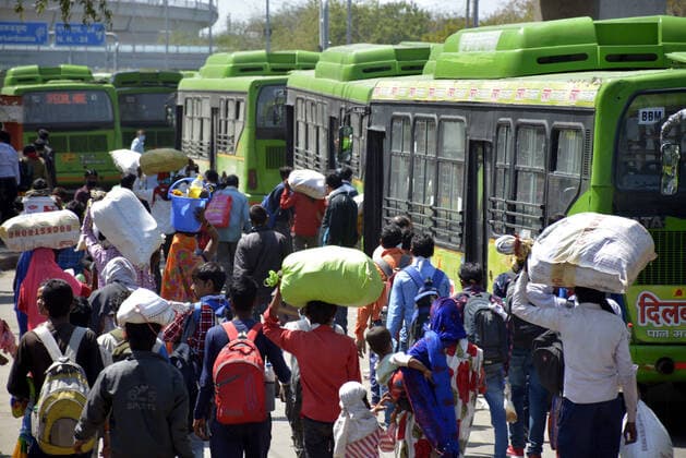 GHAZIABAD, INDIA - MARCH 29: A wave of migrant workers seen at Anand Vihar Bus Terminus as they head to their native state on Day 5 of the 21 day nationwide lockdown imposed by PM Narendra Modi to curb the spread of coronavirus, on March 29, 2020 in Ghaziabad, India. (Photo by Sakib Ali Hindustan Times ) Migrant Workers Head Home In Coronavirus Lockdown