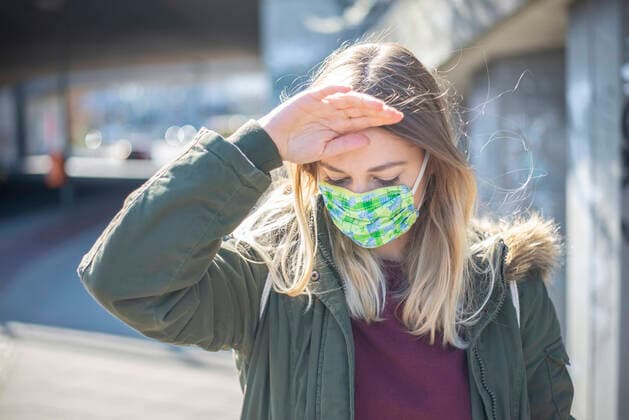 young woman with mouth guard in the city