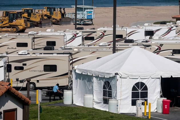 March 29, 2020, Los Angeles, California, U.S: A security man sits in RV s park at Dockweiler State Beach, in an area being used as an isolation zone for those who cannot self-isolate and are being asked to quarantine by the Los Angeles County Department of Health, amid the coronavirus pandemic on Sunday March 29, 2020 in Los Angeles, California. Los Angeles U.S. - ZUMAc68_ 20200329_zaf_c68_005 Copyright: xRingoxChiux