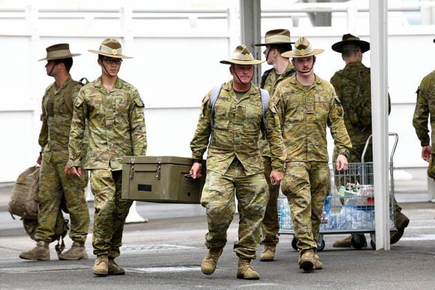 AUSTRALIA CORONAVIRUS COVID-19, Australian Defence Force (ADF) personal wait for returning overseas travellers at Sydney International Airport in Sydney, Monday, March 30, 2020. Travellers and Australian residents who arrive into the country from overseas are being sent straight to makeshift quarantine facilities across Australia. Travellers will spend 14 days of quarantine in state-funded hotel rooms, with doors guarded by state police, defence personnel or private security guards.( NO ARCHIVING, EDITORIAL USE ONLY, NO USE IN BOOKS WITHOUT CONSENT SYDNEY NSW AUSTRALIA  Copyright: xBIANCAxDExMARCHIx 20200330001460797464