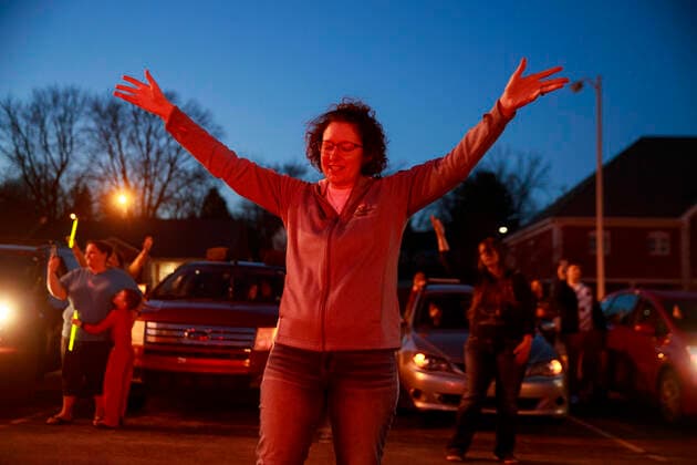 March 29, 2020, Bloomington, Indiana, United States: A group of community members from the Lighthouse Fellowship Church gather on a Sunday night outside the Bloomington Hospital to pray for doctors, nursing staff, and other workers, who are caring for patients, including some of the 22 people in Monroe County confirmed to have been sickened by COVID-19 Coronavirus..A similar prayer took place yesterday in the state of Georgia. Bloomington United States - ZUMAs197 20200329_zaa_s197_169 Copyright: xJeremyxHoganx
