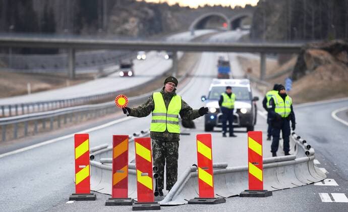 Police and soldiers check documents in the morning at a traffic control post in Lohja, Finland on March 30, 2020. The Finnish Government has decided to restrict traffic between the Region of Uusimaa and other regions to prevent coronavirus infections and to slow the spread of the epidemic in Finland. Lohja Finland  Copyright: xJussixNukarix LKLAPJ20200330073929E448