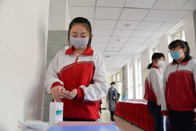 (200330) -- HOHHOT, March 30, 2020 -- A student uses hydro-alcoholic gel at the corridor of Hohhot No. 6 Middle School in Hohhot, north China s Inner Mongolia Autonomous Region, March 30, 2020. Students in their final year of senior and junior high schools in Inner Mongolia returned to school and embraced their new spring semester on Monday. ) CHINA-INNER MONGOLIA-SCHOOL REOPENING (CN) XuxQin 