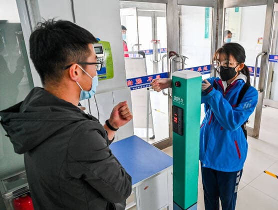(200330) -- HOHHOT, March 30, 2020 -- A graduating student gets temperature checked at the entrance of the school building of Hohhot No. 35 Middle School in Hohhot, north China s Inner Mongolia Autonomous Region, March 30, 2020. Students in their final year of senior and junior high schools in Inner Mongolia returned to school and embraced their new spring semester on Monday. ) CHINA-INNER MONGOLIA-SCHOOL REOPENING (CN) LianxZhen 