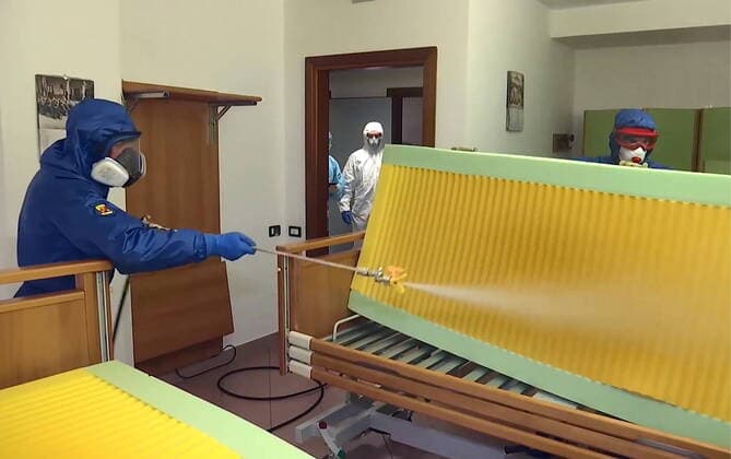LOMBARDY, ITALY - MARCH 30, 2020: A brigade of Russian epidemiologists and experts of the Troops of Radiological, Chemical and Biological Defence of the Russian Defence Ministry together with Italian military specialists carry out a full disinfection of the Casa Serena residence for senior citizens in the town of Leffe, the province of Bergamo. Video screen grab. Russian Defence Ministry TASS  TS0D3D90