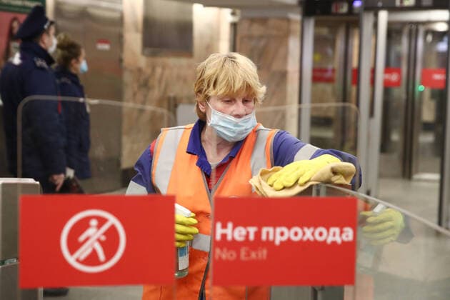 MOSCOW, RUSSIA - MARCH 30, 2020: An employee washes ticket barriers at Polezhaevskaya Station of the Moscow Metro. Russian President Vladimir Putin declared a week off work from 28 March to 5 April 2020 and urged people to stay home to curb the spread of the coronavirus infection. From 30 March 2020, the Moscow government has imposed home isolation for all Moscow residents, regardless of their age. Sergei Fadeichev TASS  TS0D3D7E