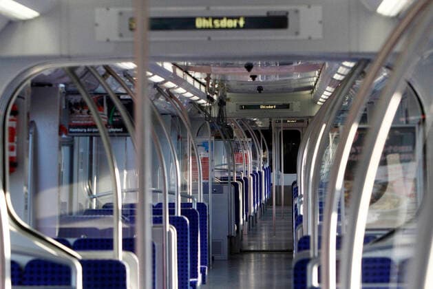 The conoravirus crisis and extended exit restrictions of the authorities lead more and more to a decline in public life and collapse of demand for public transport deserted S-Bahn line 1 in Hamburg, Germany