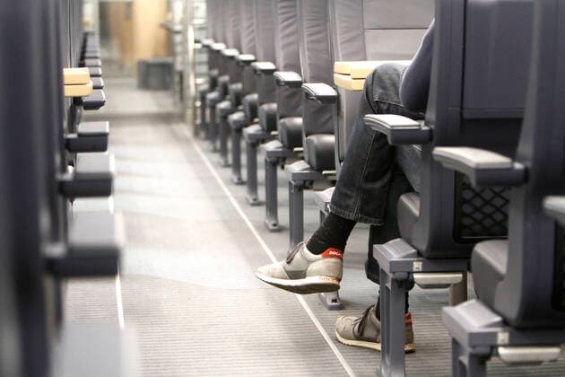 The conoravirus crisis and extended initial restrictions by the authorities are leading more and more to a decline in public life s and restriction of individual mobility except for one passenger of deserted 1 class passenger cars of an ICE s of DB Deutsche n Bahn in Frankfurt, Hesse, Germany