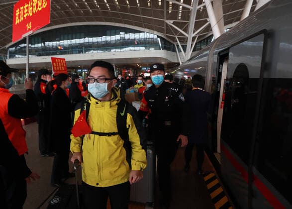 (200330) -- WUHAN, March 30, 2020 -- Medical workers board the train at Wuhan Railway Station in Wuhan, central China s Hubei Province, March 30, 2020. A total of 132 medical workers from the Third Xiangya Hospital of Central South University in Hunan left Wuhan on Monday after finishing their task. (Photo by Xinhua) CHINA-WUHAN-COVID-19-MEDICS FROM HUNAN PROVINCE-DEPARTURE (CN) ZhaoxJun 