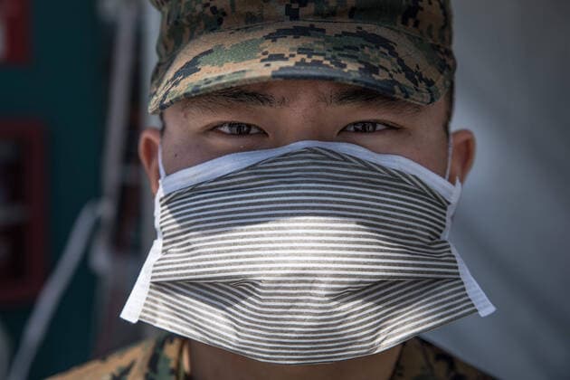 March 29, 2020, Los Angeles, CA, United States of America: U.S. U.S. Marine Pfc. Brandon Shim, wearing personal protective equipment, guards the checkpoint for the Military Sealift Command hospital ship USNS Mercy as it begins treating patients in support of the COVID-19 pandemic March 29, 2020 in Los Angeles, California. Los Angeles United States of America - ZUMAp138 20200329_zaa_p138_004 Copyright: xAlexaxHernandez U.S.xNavyx