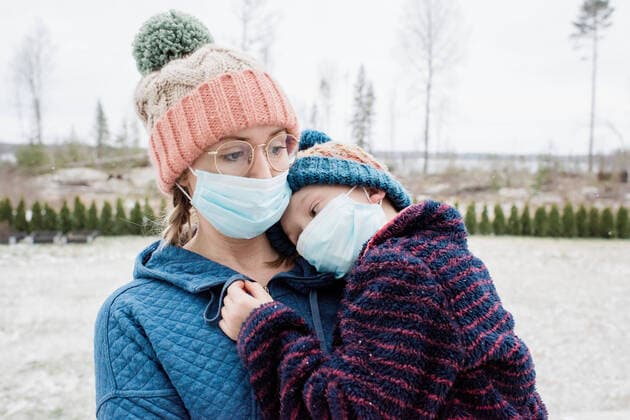 mother carrying son with face masks on as protection from virus & flu NorrtoÂ¤lje, Stockholm County, Sweden ,model released, Symbolfoto CR_RABE200313B-319706-01