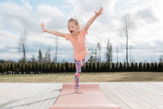 Creative Highlights Symbol young girl balancing on a yoga mat in her back yard at home NorrtoÂ¤lje, Stockholm County, Sweden ,model released, Symbolfoto CR_RABE200318-320973-01