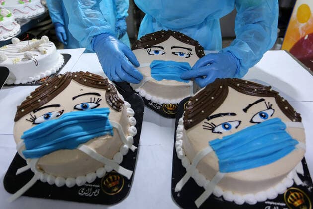 March 30, 2020, Khan Yunis, Gaza Strip, Palestinian Territory: Palestinians put final touches on cakes that portrays a woman wearing a facemask, at their shop in Khan Yunis in the southern Gaza Strip on March 30, 2020. The United Nations has warned that a COVID-19 outbreak in Gaza could be disastrous, given the high poverty rates and weak health system in the coastal strip under Israeli blockade since 2007. Authorities in Gaza have said that more than 2,700 Palestinians are in home-isolation, mostly people who had returned from Egypt Khan Yunis Palestinian Territory - ZUMAap3_ 20200330_zaf_ap3_133 Copyright: xAshrafxAmrax