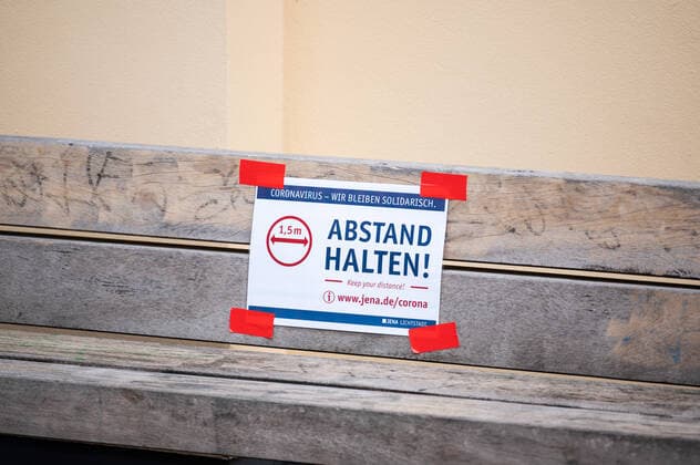 Sticker with the request to keep 1 5m distance on a bench in the center of Jena on 30 3 2020 downtown Jena