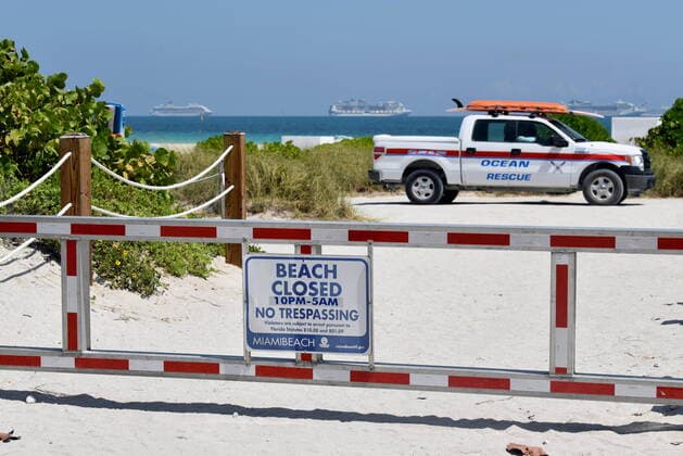 March 26, 2020, Miami Beach, Florida, USA: Ocean Rescue patrol the empty beaches of South Beach due emergency measures implemented by the City of Miami Beach to the Covid-19 pandemic closing all parks, beaches, recreational facilities, restaurants, cafes and hotels. Cruise ships empty of passengers can be seen in the distance waiting their turn to dock at the Port of Miami. Miami Beach USA  - ZUMA Pho 20200326_mda_a324_361 Copyright: xTaimyxAlvarezx