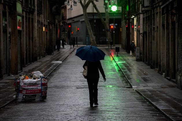 March 30, 2020, Barcelona, Catalonia, Spain: A woman walks the empty streets of Barcelona downtown under the rain. Daily coronavirus deaths fall slightly with 812 Covid-19 victims in the last 24 hours in Spain, Spanish government has ordered new lockdown restrictions. Barcelona Spain - ZUMAb137 20200330_zap_b137_015 Copyright: xJordixBoixareux