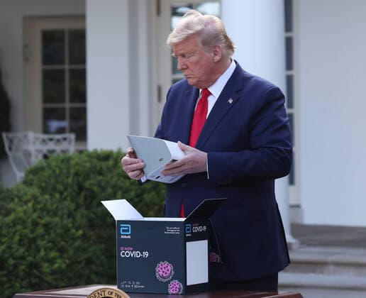 March 30, 2020, Washington, District of Columbia, USA: US President Donald J. Trump opens the Abbot ID NOW COVID-19 test box during the Coronavirus Task Force press briefing on the coronavirus and COVID-19 pandemic, in the Rose Garden at the White House, in Washington, DC, USA, 30 March 2020 Washington USA - ZUMAs152 20200330_zaa_s152_012 Copyright: xMichaelxReynoldsx