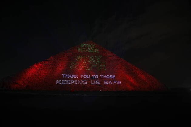 (200331) -- GIZA, March 31, 2020 (Xinhua) -- Photo taken on March 30, 2020 shows the view of the Pyramid of Khufu illuminated with text Stay home, stay safe, thank you to those keeping us safe in Giza, Egypt. Egypt said on Monday it has recorded 47 new COVID-19 positive cases and one more death, raising the number of confirmed cases to 656 and the death toll to 41. (Str Xinhua) EGYPT-GIZA-COVID-19-PYRAMIDS-ILLUMINATION 