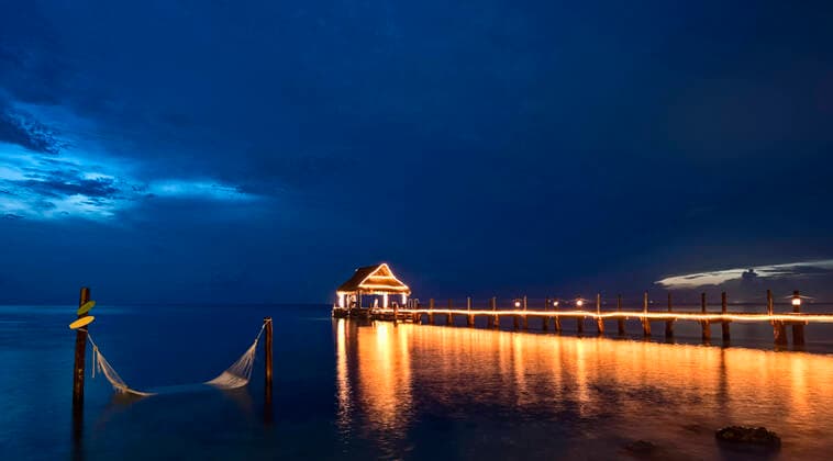 Night pier view on the sea illuminated with hammock on the water San Miguel de Cozumel, Q.R., Mexico ,editorial use only CR_SGVZ200323B-328657-01