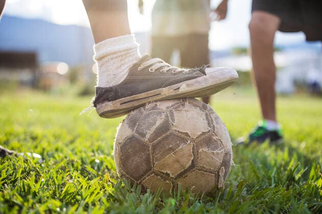 Soccer (football) player places old shoe on torn soccer ball. Monjas, Jalapa Department, Guatemala ,property released CR_JDIP200326A-316093-01