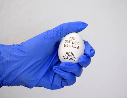 31 03 2020, Symbol picture egg and rubber gloves We stay at home on a hens egg A slogan because of the exit restriction in Germany 31 03 2020, egg and rubber gloves 31 03 2020, egg and rubber gloves