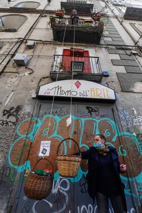 A solidarity basket with a note reading Who can may put, who cannot may take is displayed in one of the deserted streets in the historic center of Naples, southern Italy.After a government decree declaring all of Italy a protected area to combat covid -19 coronavirus infection.  Copyright: xSalvatorexLaportax xIPAx xKontrolabx