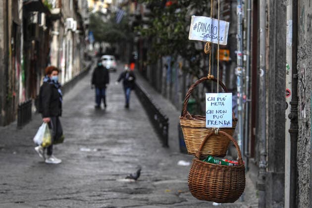 A solidarity basket with a note reading Who can may put, who cannot may take is displayed in one of the deserted streets in the historic center of Naples, southern Italy.After a government decree declaring all of Italy a protected area to combat covid -19 coronavirus infection.  Copyright: xSalvatorexLaportax xIPAx xKontrolabx