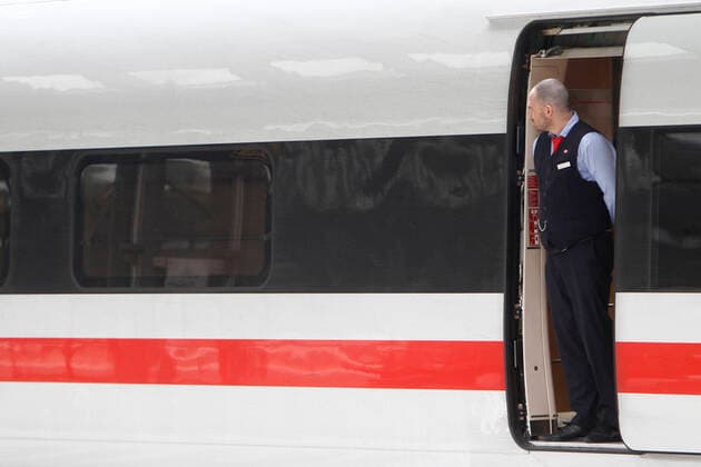 The conoravirus crisis and extended exit restrictions imposed by the authorities are increasingly leading to a decline in public life and restriction of individual mobility DB Deutsche Bahn employees are waiting in the dining car door for passengers at Frankfurt Central Station, Hesse, Germany